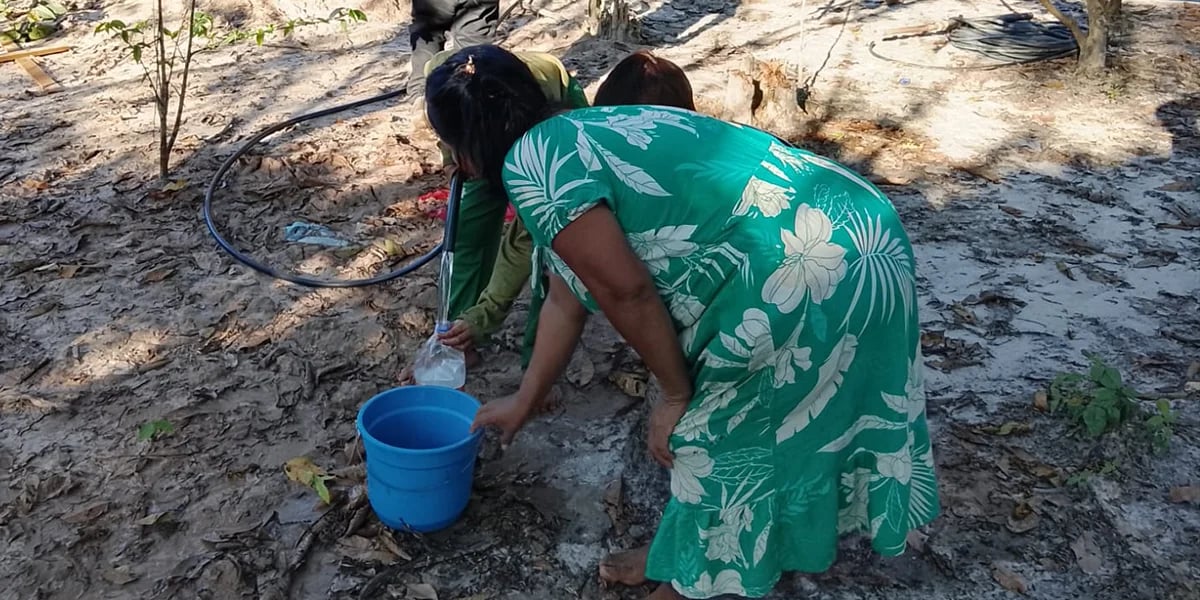 People filling water containers outdoors