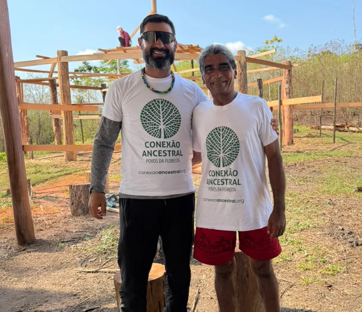 Indigenous man with a child and another community member